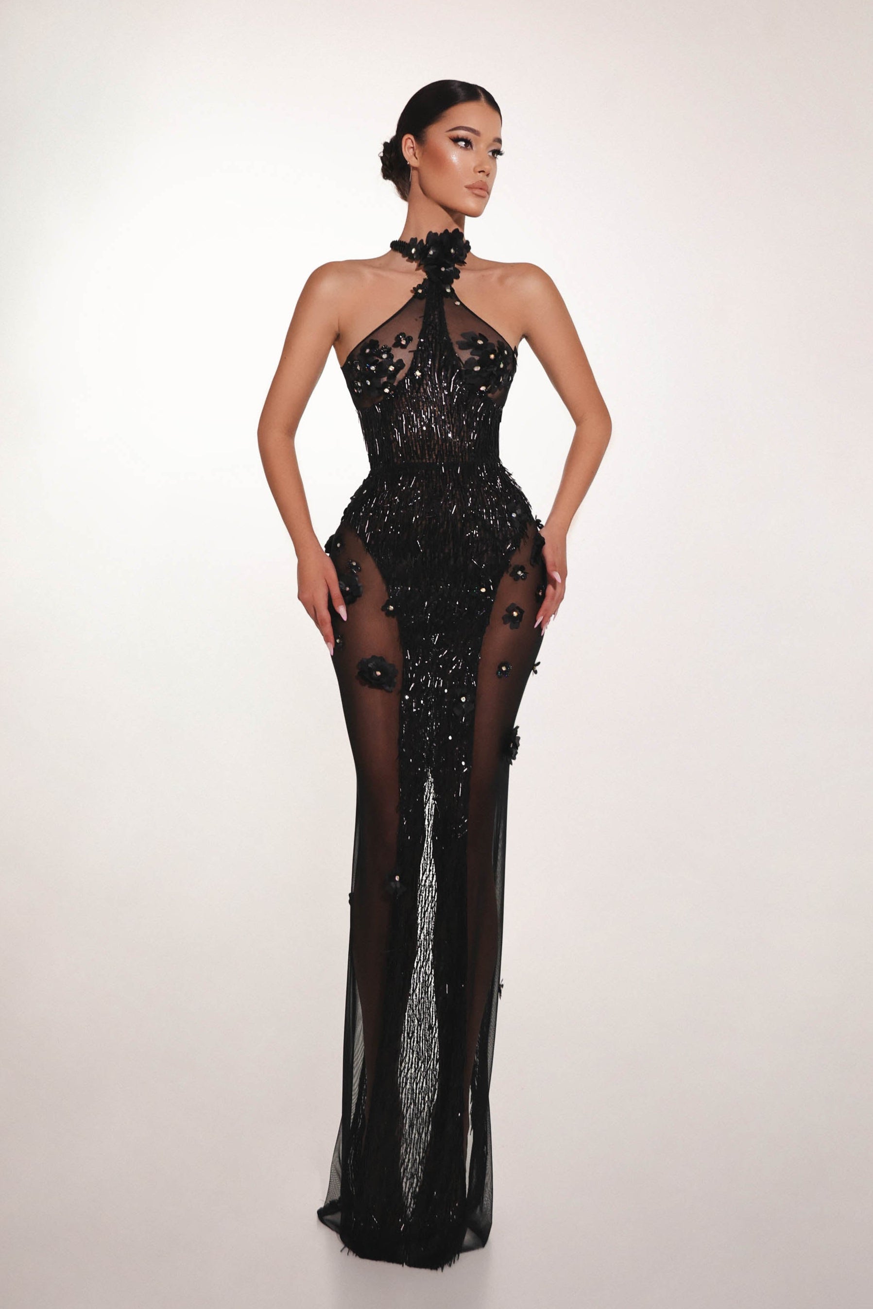 Black embellished couture evening dress with sheer details and sculpted silhouette