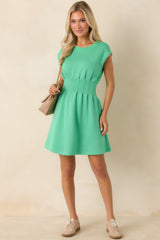 Mini dress in soft knit with subtle cinched waist and cap sleeves.