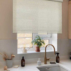 Beige roller blind over kitchen window