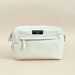 Oyster white dog walking bag by Cocopup London, small rectangular pouch with zipper and logo label on a plain background.