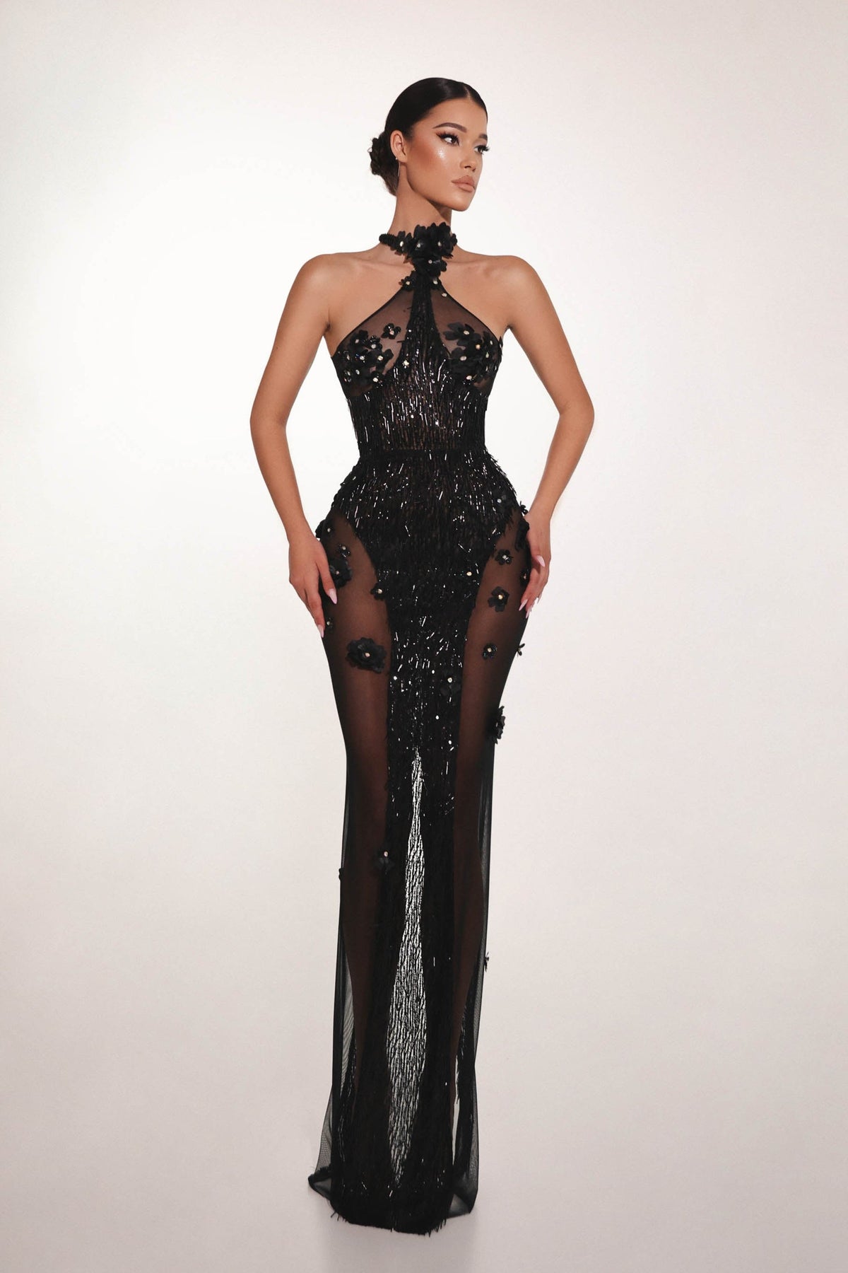 Black embellished couture evening dress with sheer details and sculpted silhouette