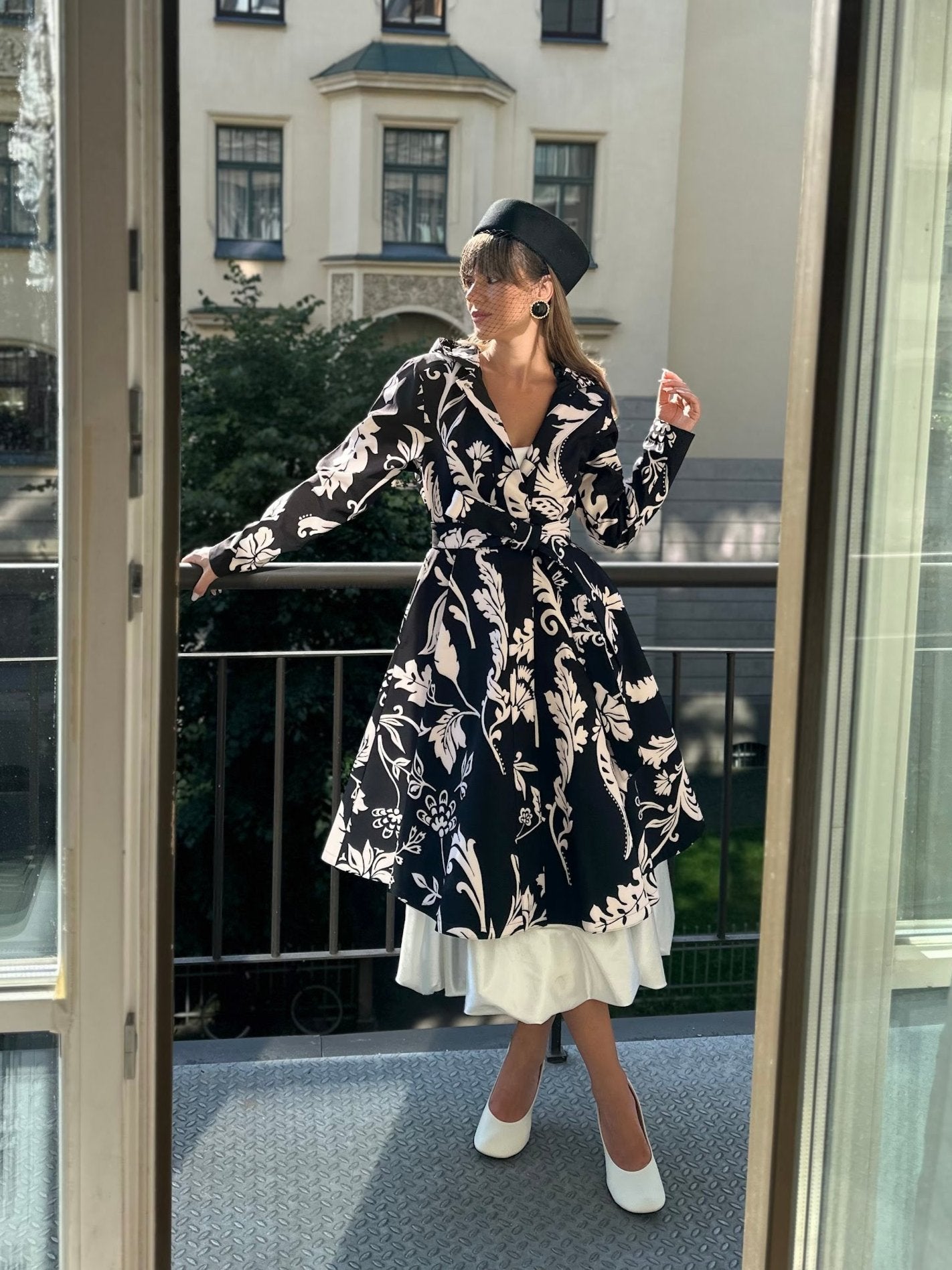Black and white floral women's coat worn as chic outerwear