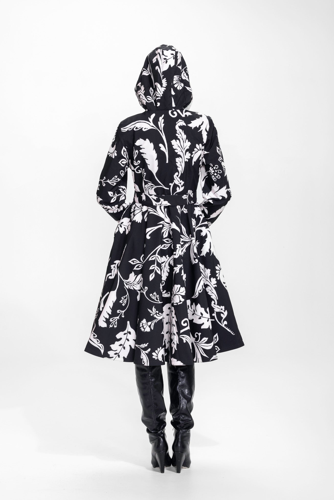 Back view of black floral women's coat with fitted waist and full skirt